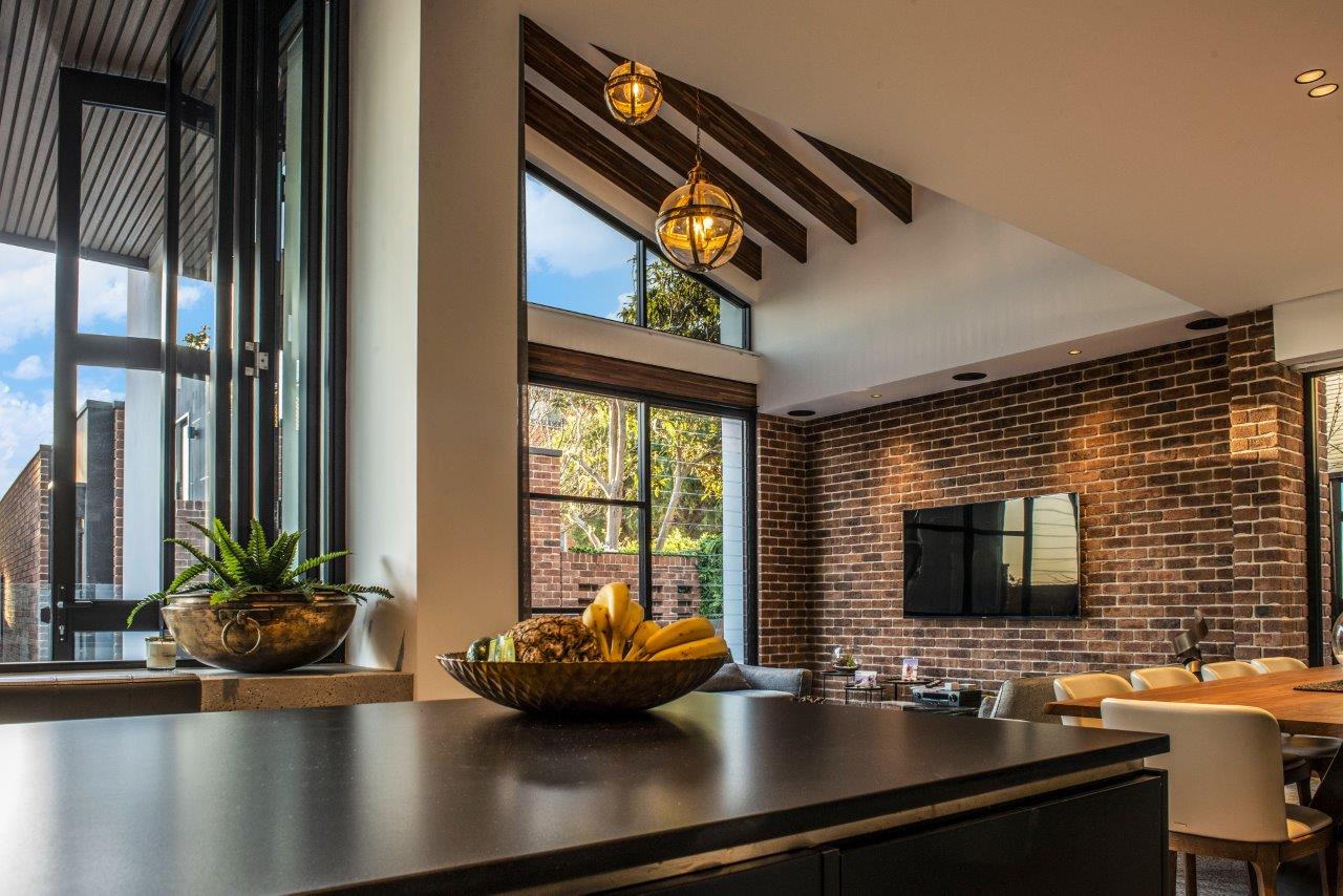 https://www.es.au/application/assets/2022/04/living_kitchen_design_brick_feature.jpg